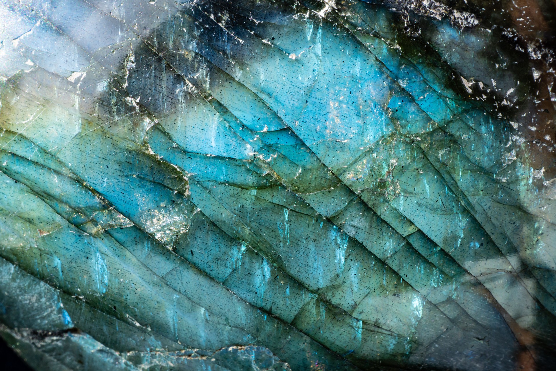 Macro photo of a colorful and illuminated labradorite stone with iridescent textures and luminous colors.